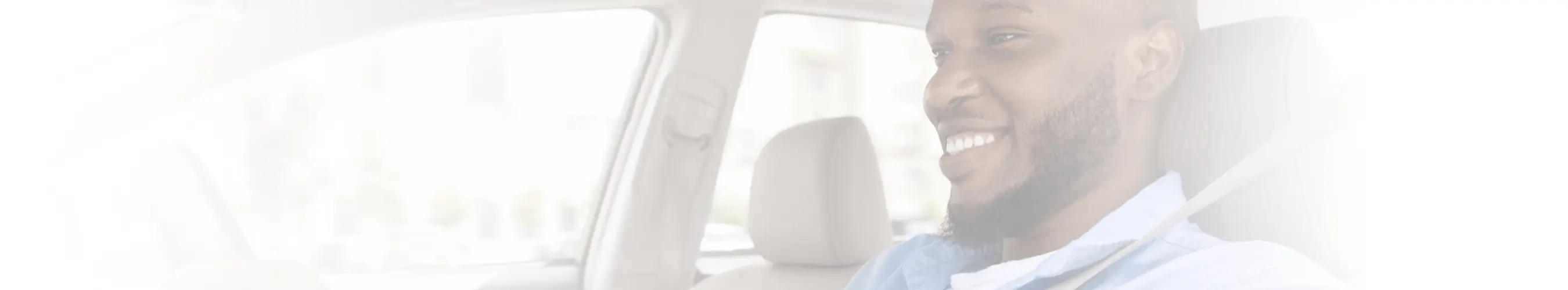 Smiling man driving a car